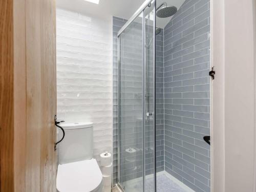a bathroom with a toilet and a glass shower at 2 Bed in Formby 90263 