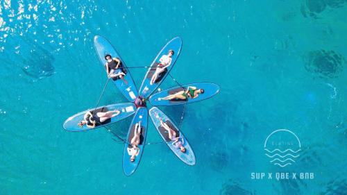 a group of people on surfboards in the water at QBE B&B in Nanwan