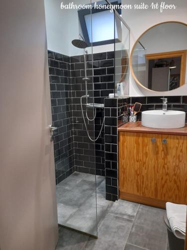a bathroom with a sink and a mirror at Espirito do Mar - Premium Villa with Jacuzzi in Estreito da Calheta