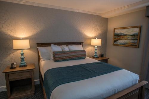 a bedroom with a large bed with two lamps at The Spa at Norwich Inn in Norwich