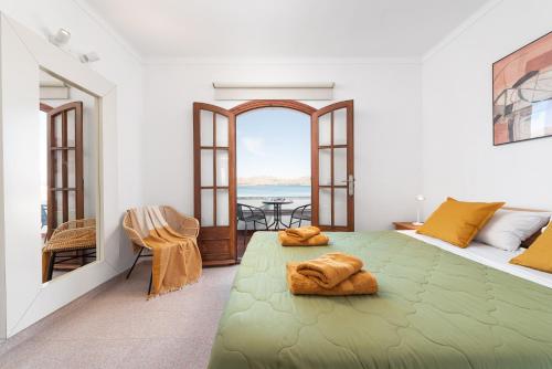 a bedroom with a green bed with a view of the ocean at SES ONES with sea views in Alcudia