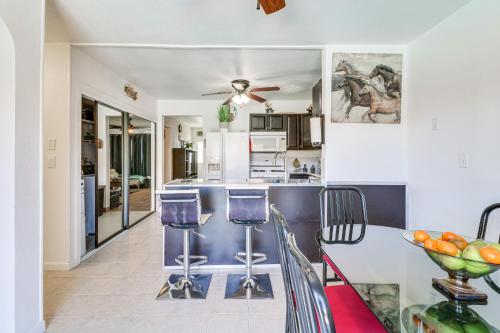a kitchen and dining room with a table and chairs at Palmdale Family Home with Private Pool and Backyard in Palmdale