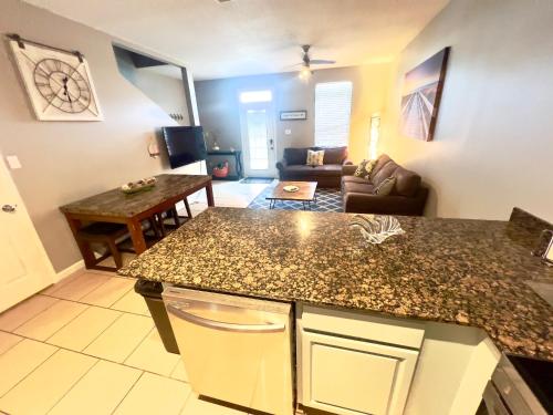 a kitchen and living room with a counter top at Sandy Feet Retreat MS in Gulfport