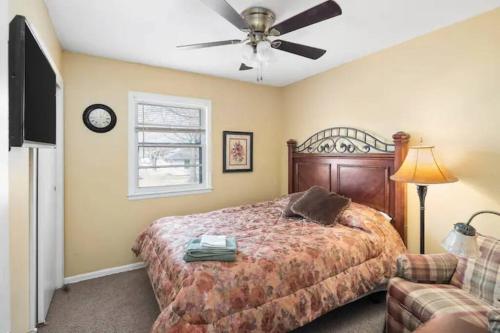 a bedroom with a bed and a ceiling fan at The Retreat House, Olathe in Olathe