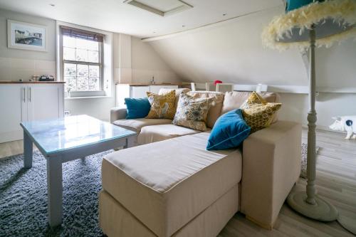 a living room with a couch and a table at The George in Bradford on Avon