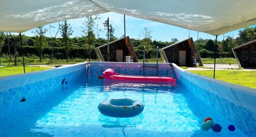 a swimming pool with a slide and an inflatable at Starium Seocheon in Seocheon