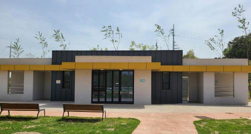 a building with two benches in front of it at Starium Seocheon in Seocheon