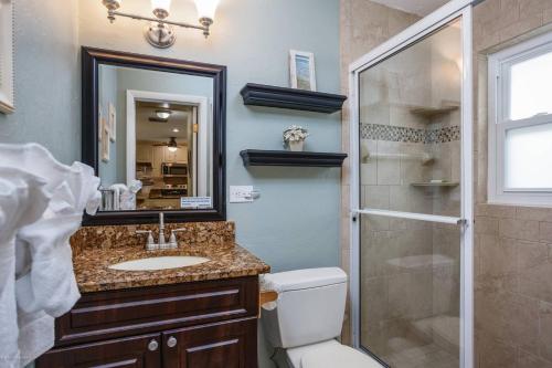 a bathroom with a toilet and a sink and a shower at Jamaica Royale Beach Happiness in Siesta Key