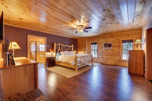 a bedroom with a bed and a wooden ceiling at Waterfront Old Forge Cabin with Deck and Indoor Pool in Old Forge