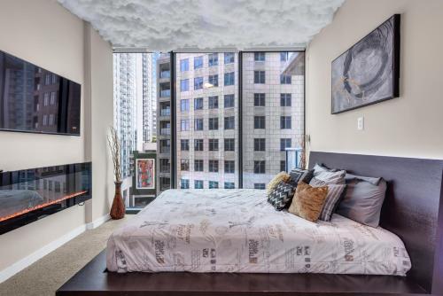 a bedroom with a bed and a large window at Lenox Mall Buckhead City Views in Atlanta