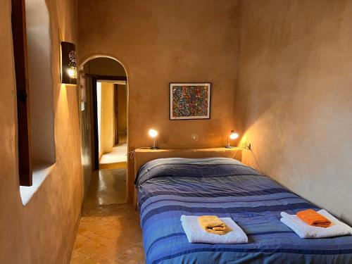 a bedroom with a bed with towels on it at Dar Les Dattiers in Taroudant