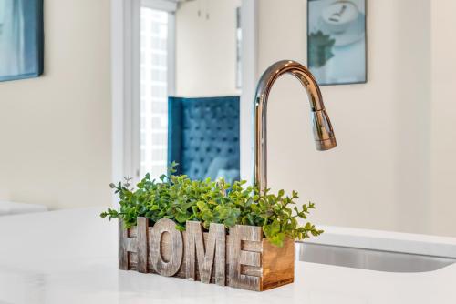 a kitchen sink with a home sign on a counter at Lenox Mall Buckhead City Views in Atlanta