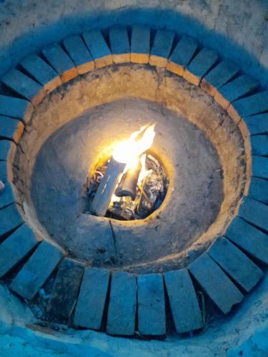 an old brick oven with a fire in it at Cabin in the Mountains - Chalet in Ibagué