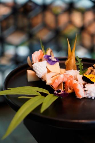 a plate of food with sushi on a table at Marco Polo Xiamen in Xiamen