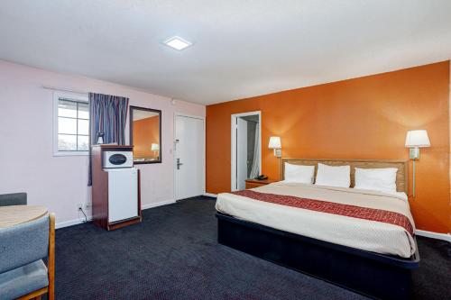 a hotel room with a large bed and a television at Regency Inn in Fayetteville