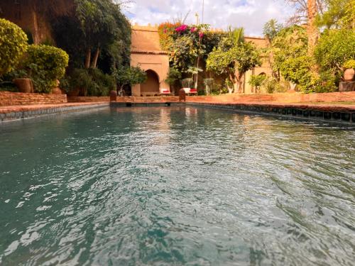 a pool of water in front of a building at Dar Les Dattiers in Taroudant