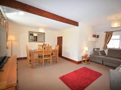 a living room with a table and a dining room at 2 Bed in Sidmouth BURSC in Sidbury