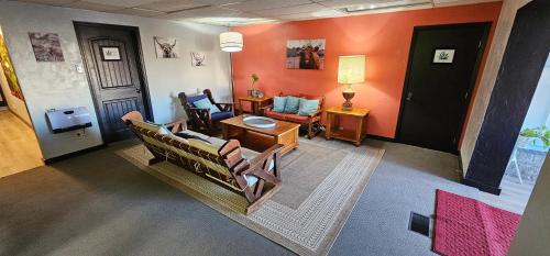 an overhead view of a living room with orange walls at The Canna House by High Society Rentals in Clovis