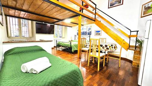 a bedroom with a green bed and a dining room at A Casa Simpatia - Check-in Via Bixio, 41 in Rome