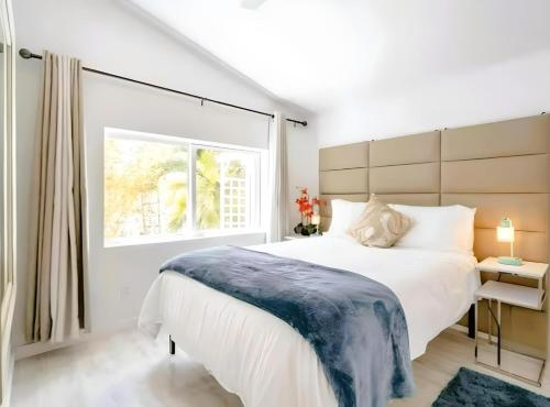 a bedroom with a large white bed and a window at Heated pool just 1.7 mi to beach The Ocean Pearl in Sarasota