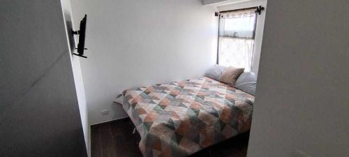 a bedroom with a bed in a room with a window at Apartamento zona 1, Ciudad de Guatemala in Guatemala