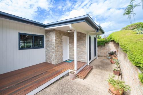 a house with a wooden deck at Holiday on The Horizon Airlie Beach Holiday Home in Airlie Beach