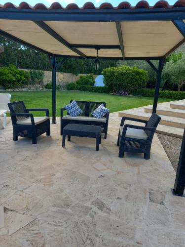 a group of chairs and a table under a gazebo at Villa enseñat ETV04085 in Pollença