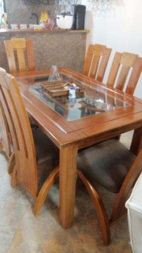 a wooden table and chairs with a glass top at VILLA DEL SOL PURIFICACIÓN TOLIMA in Purificación