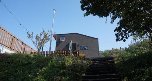 a house on a hill with stairs leading to it at Starium Jecheon in Jecheon