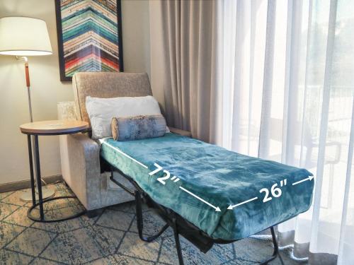 a room with a couch and a chair with a blanket at Matterhorn Inn in Sedona