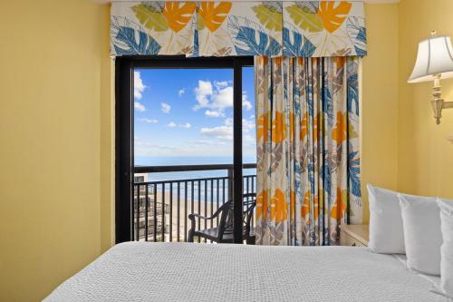 a bedroom with a bed and a window with a view at Ocean Reef 925 in Myrtle Beach