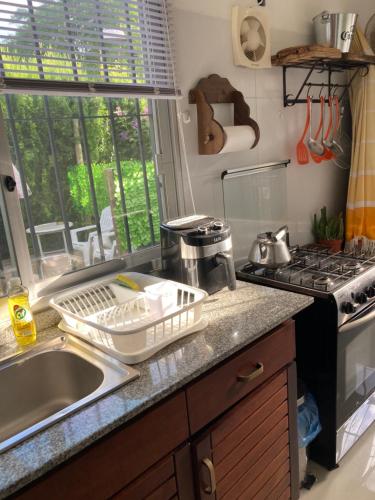 a kitchen counter with a sink and a stove at Mar 11 a 100 mtros del mar in Parque del Plata