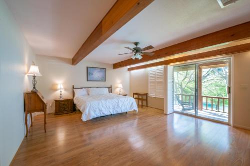 a bedroom with a bed and a wooden ceiling at Guadalupe River Getaway - 140 Feet of Beautiful Waterfront! in New Braunfels