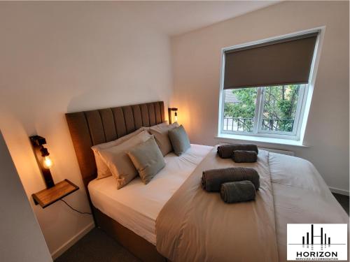 a bedroom with a large bed with a window at FREE Parking-Waterfront- Victoria Dock-Siemens-Contractors-Relocators in Hull