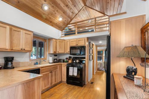 a kitchen with wooden cabinets and a black stove top oven at The Cabins at Hyatt in Ashland
