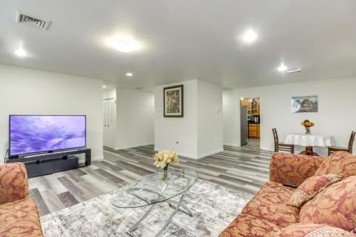 a living room with a couch and a flat screen tv at Family-Friendly Home in Bowie with Fenced Yard! in Bowie