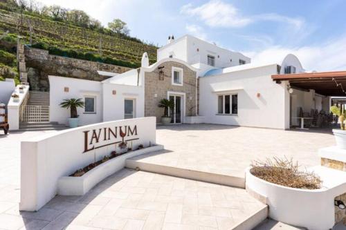 a white house with a patio and a building at Lavinum in Monte di Procida
