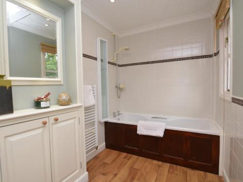 a white bathroom with a tub and a sink at 2 Bed in Sherborne 53673 in Chetnole