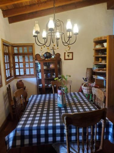 a dining room with a checkered table and chairs at Glamping Teques Naturaleza de lujo Granja El Sol in Xoxocotla