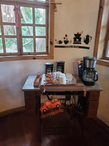 a room with a table with a coffee maker on it at Glamping Teques Naturaleza de lujo Granja El Sol in Xoxocotla