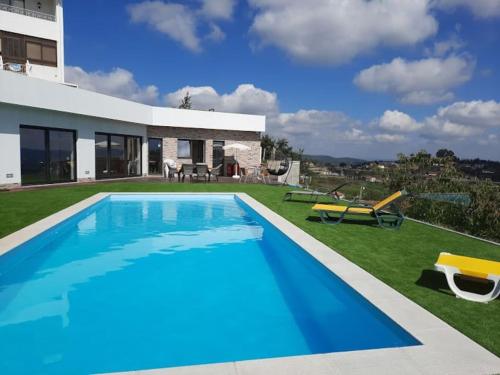 a villa with a swimming pool and a house at Varandas da Vista Alegre in Arouca
