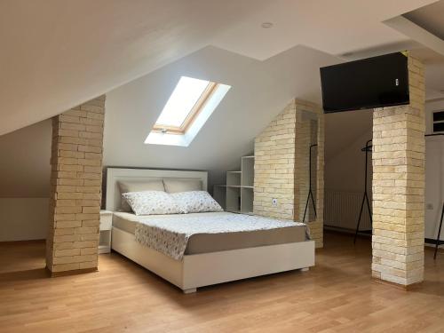 a bedroom with a bed and a skylight at Art Studio in Niš