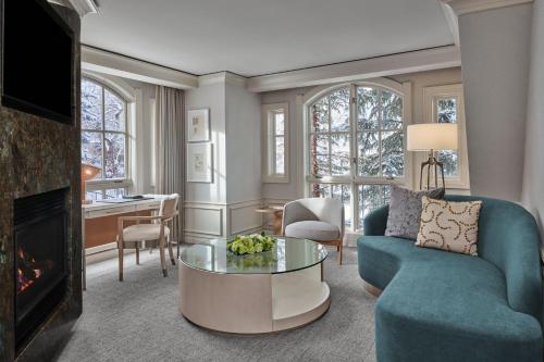 a living room with a blue couch and a table at St. Regis Aspen Resort in Aspen