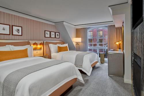 a hotel room with two beds and a window at St. Regis Aspen Resort in Aspen
