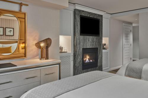 a bedroom with a bed and a fireplace at St. Regis Aspen Resort in Aspen