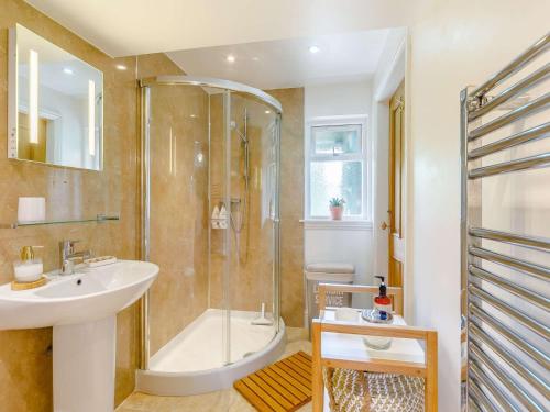 a bathroom with a shower and a sink and a tub at 3 bed property in Swinton 89133 in Swinton