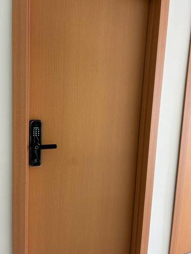 a wooden door with a black door knob on it at Loft Solaris Apart Hotel - Suíte - Apt. N.103 in João Câmara