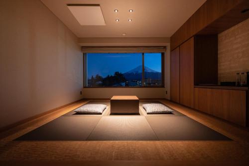 a meditation room with a large window and two meditation mats at Oike Hotel in Fujikawaguchiko