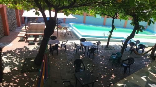 a group of tables and chairs next to a swimming pool at Longboard Hotel in La Libertad