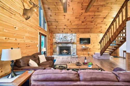 a living room with a couch and a fireplace at NEW HOT TUB! Secluded 3 Bed Cabin in Pigeon Forge in Pigeon Forge